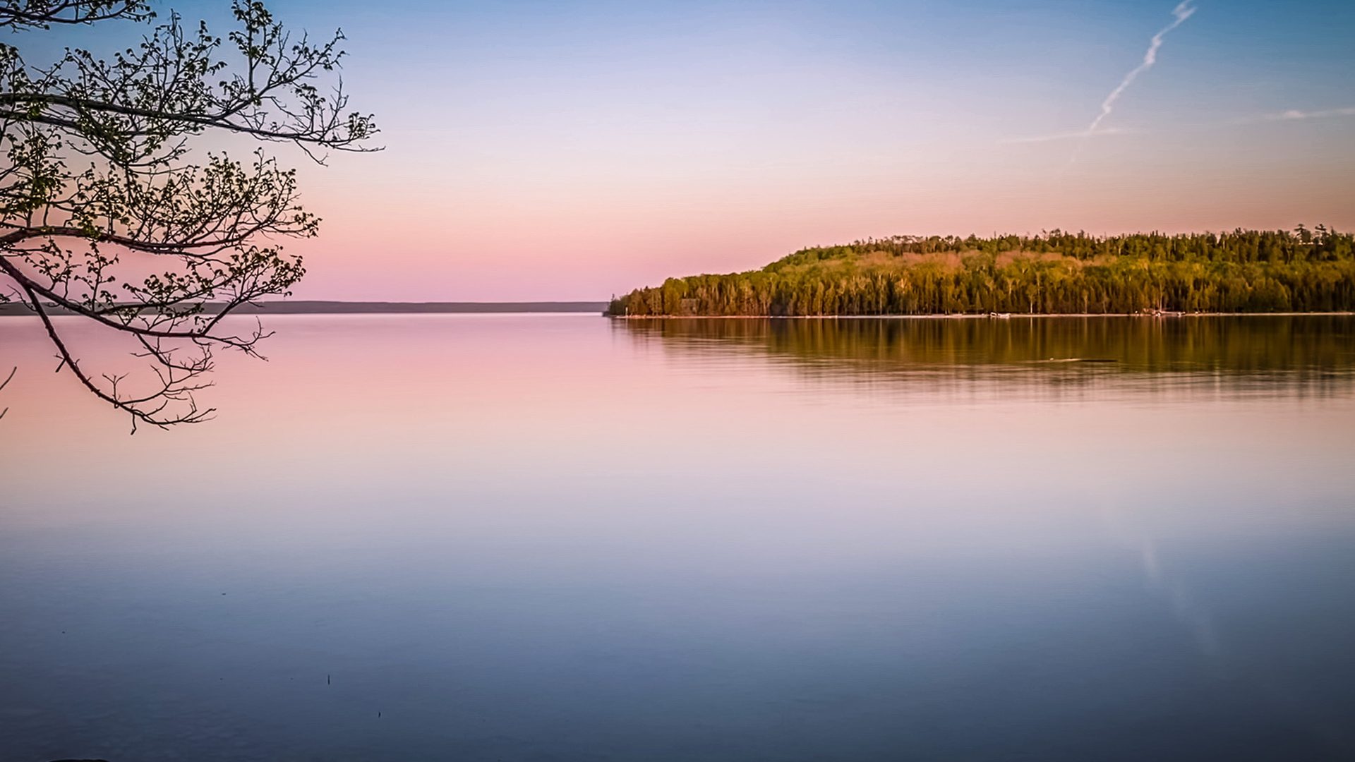 Calm lake at twilight, soft pastel sky and mirror reflections